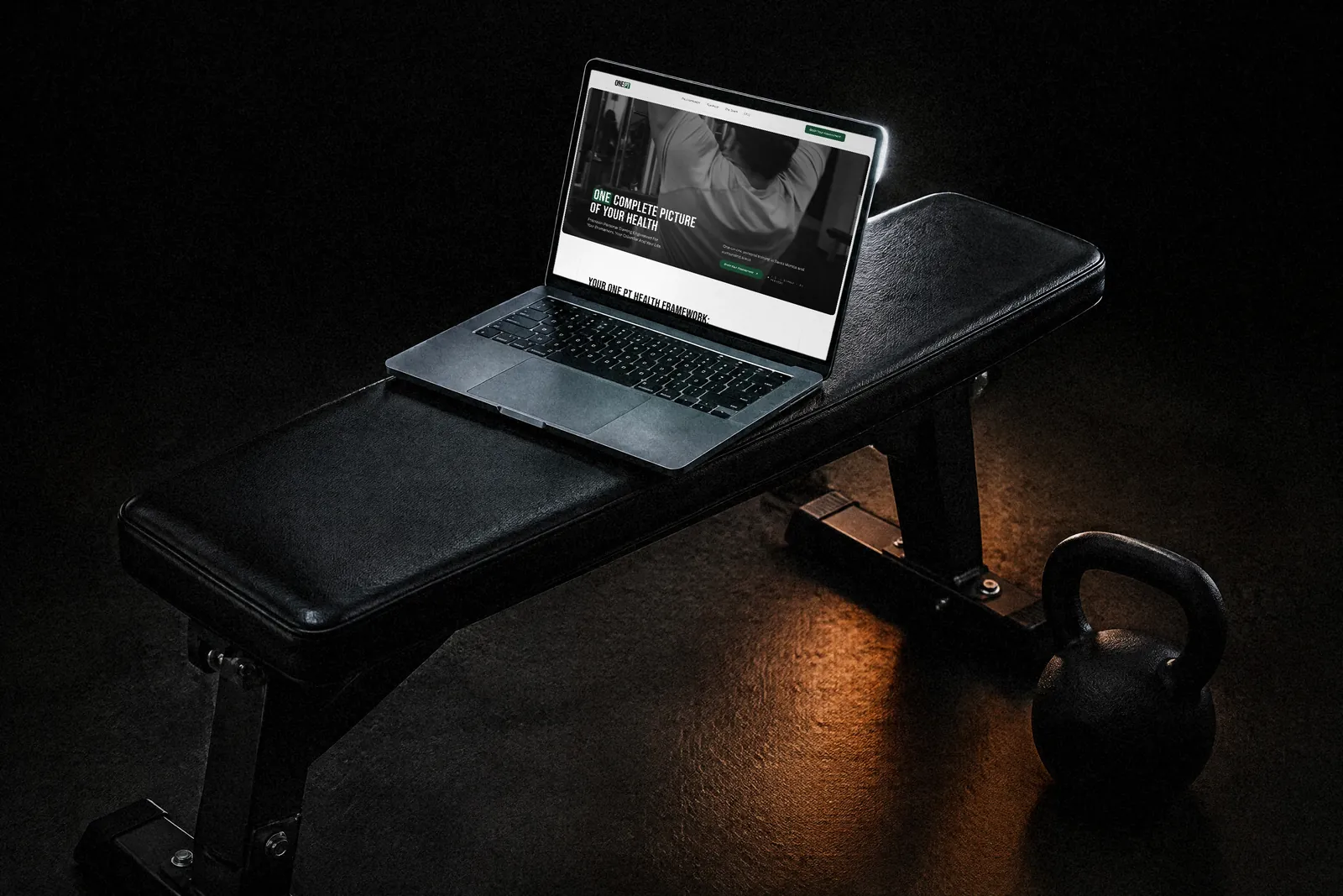 One PT personal training landing page shown on a laptop